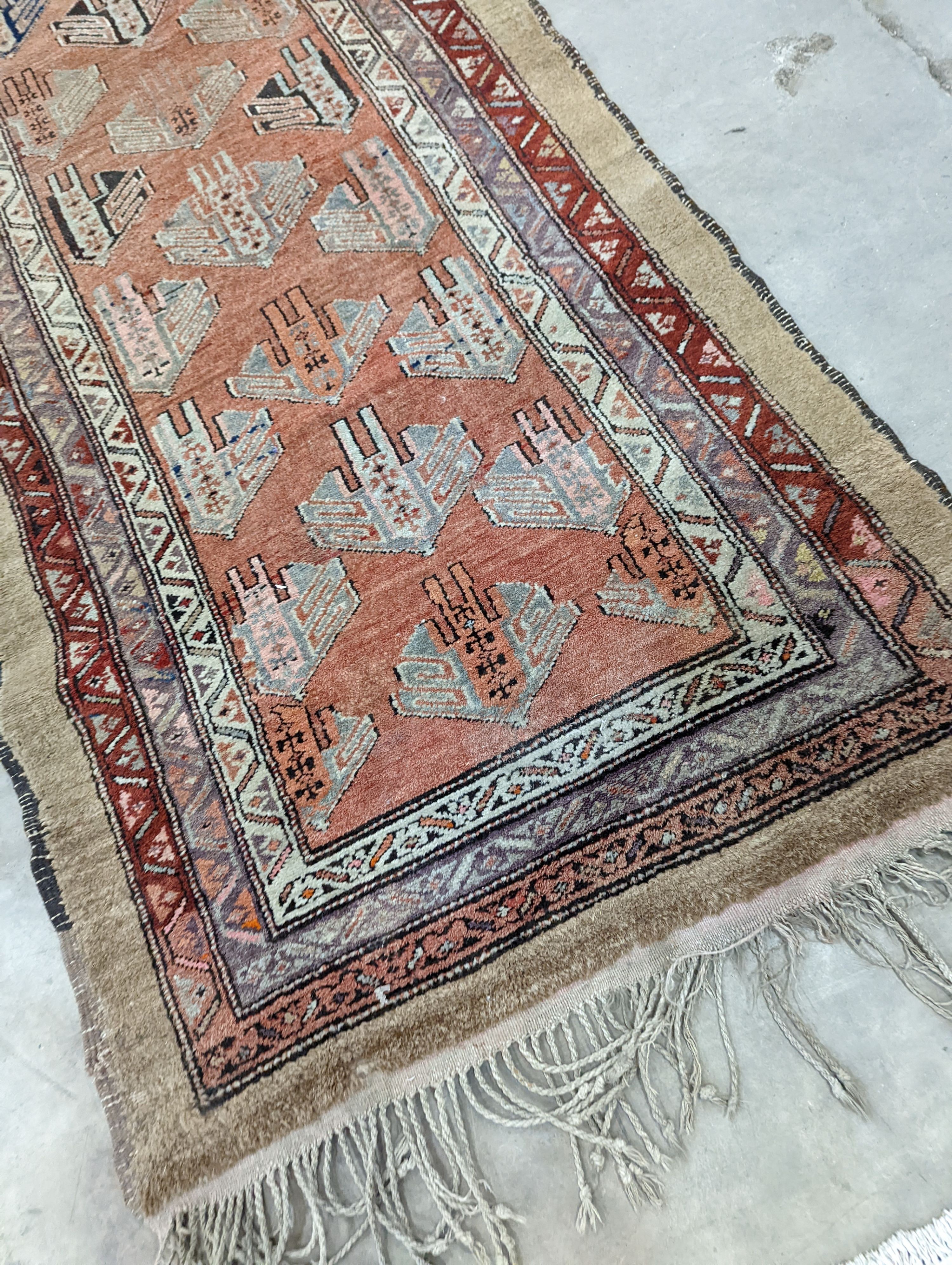 An Afghan brick red ground geometric runner and a smaller Afghan rug, larger 306 x 106cm